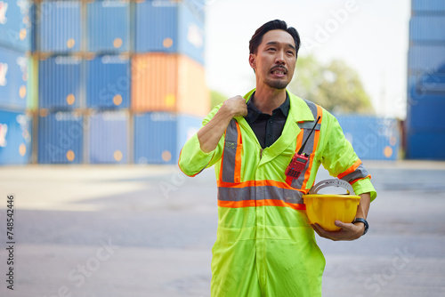 technician or worker feeling tired from work in containers warehouse storage photo