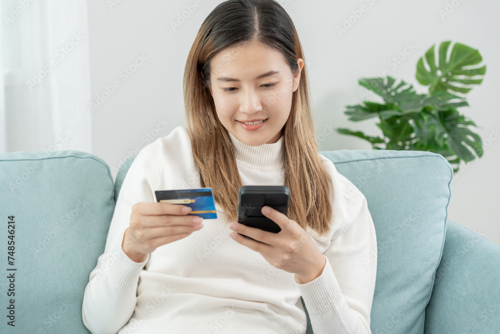 woman using smartphone for online shopping at home. Hand holding mobile phone with payment detail page display and credit card, stay home, technology, electronic commerce, internet, market place woman using smartphone for online shopping at home. Hand holding mobile phone with payment detail page display and credit card, stay home, technology, electronic commerce, internet, market place