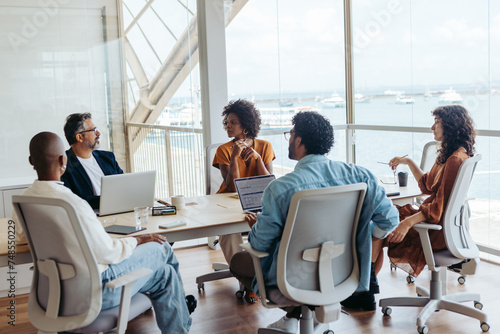 Business people collaborating and discussing ideas in a modern office photo
