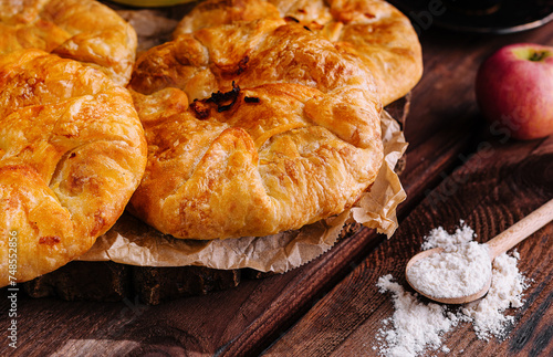 Cooking traditional pies with apple and pumpkin on wooden board photo