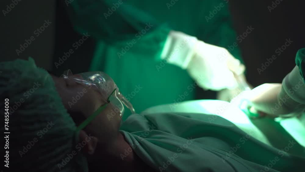 Team of surgical doctor performing a surgery in operating room. Team of surgical doctor performing a surgery in operating room.