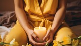 Close-up of women's hands with candles. Atmospheric image of flowers and candles. Harmony and balance. Femininity and tenderness.