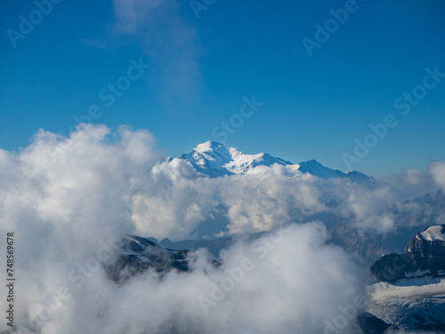 Champery, Switzerland - September 10th 2023: Distant view towards Mont Blanc peak through clouds