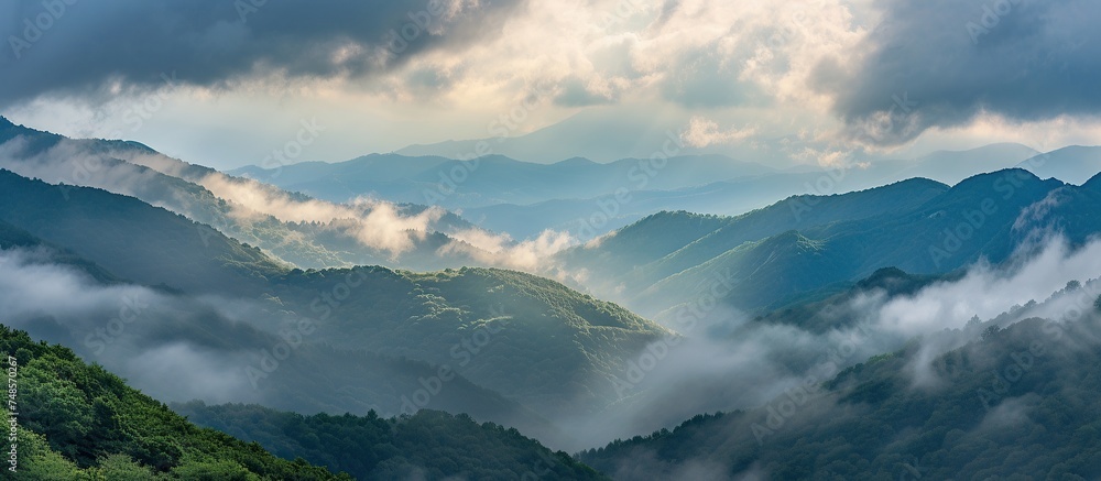 mountain views covered by thick clouds during the day. mountain views covered by thick clouds during the day.