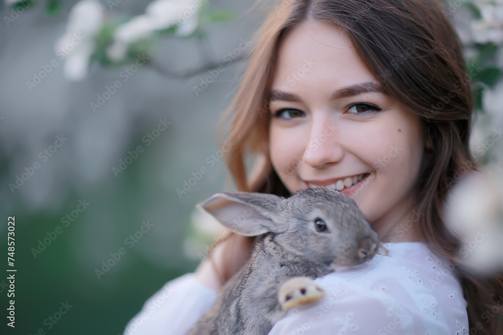 easter bunny in the hands of a beautiful girl, spring, april in a blooming garden, portrait of a woman easter bunny in the hands of a beautiful girl, spring, april in a blooming garden, portrait of a woman
