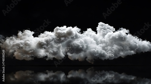 A large white cloud is floating in a black sky. The cloud is soft and fluffy, and it looks like it is made of cotton. photo