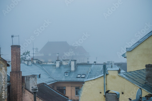 Old town in the fog. Roofs of houses on a foggy morning in Lviv. Old houses in the fog. Ukraine. © decorator