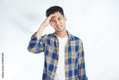 Adult Asian man got painful migrain gesture photo