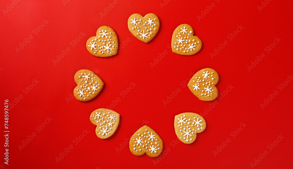 beautiful hand-baked cookies in the shape of a heart on a red background beautiful hand-baked cookies in the shape of a heart on a red background