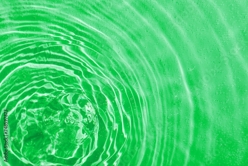 drops on water with circles on a green background © Minakryn Ruslan 