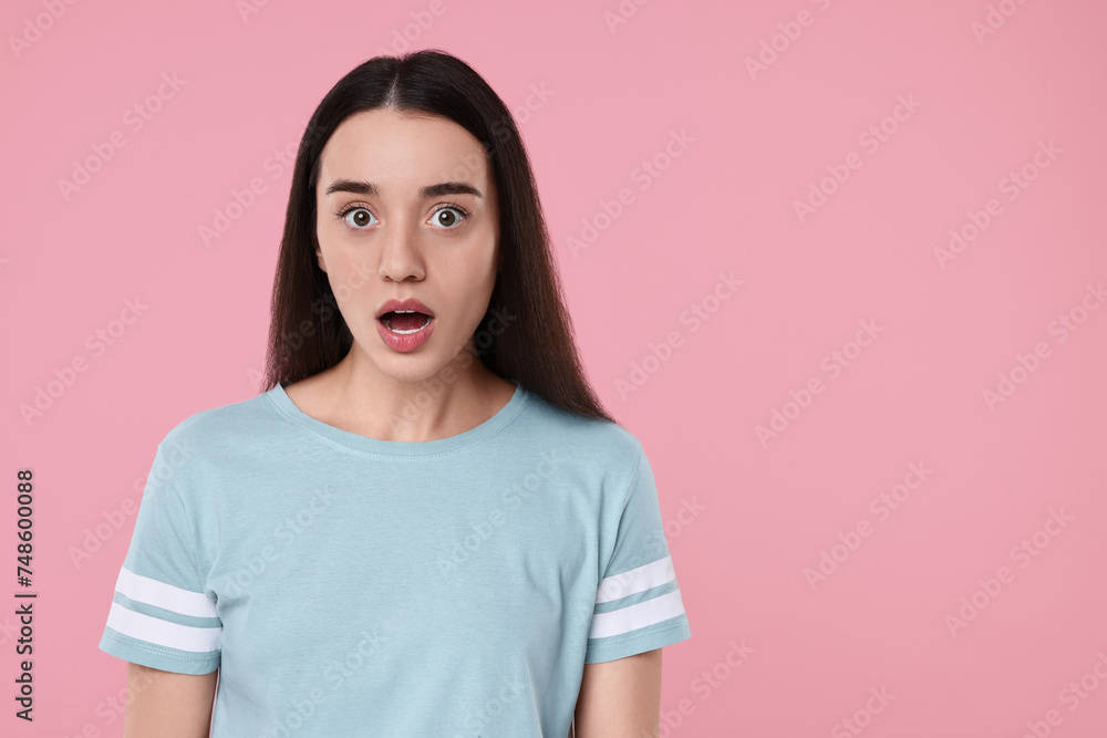 Portrait of surprised woman on pink background. Space for text Portrait of surprised woman on pink background. Space for text