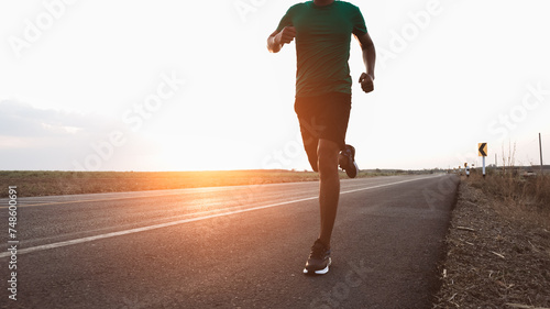 Runner running on old countryside road the land and scenery of a rural area. they running the surrounding.