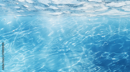 Transparent blue clear water surface texture with ripples, splashes and bubbles. summer banner background Water waves in sunlight with copy space, underwater background