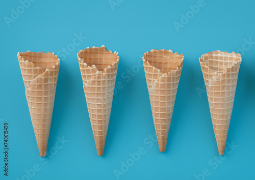 Ice cream cones on blue background. Flat lay, top view.