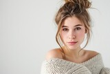 Pretty Young Woman in Off-the-Shoulder Sweater and Messy Bun photo on white isolated background --ar 3:2 --v 6 Job ID: 3426d64d-ac6f-4f6b-ad29-2b2a1eb1dafd
