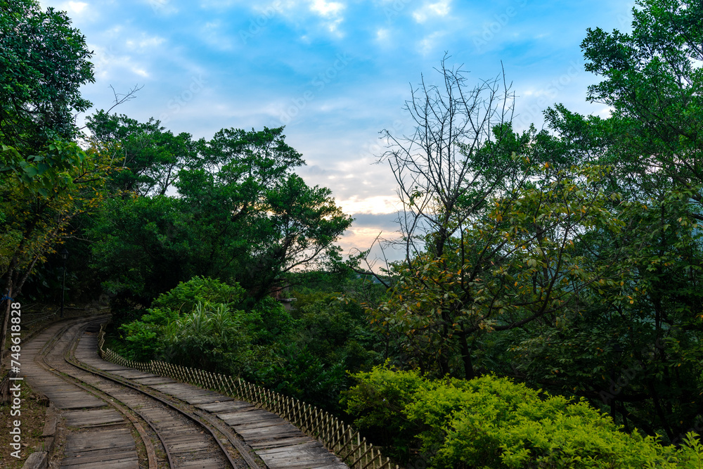 Abandoned train way in the mountain with green plants surrounded, in Jinguashi, New Taipei City, Taiwan. Abandoned train way in the mountain with green plants surrounded, in Jinguashi, New Taipei City, Taiwan.