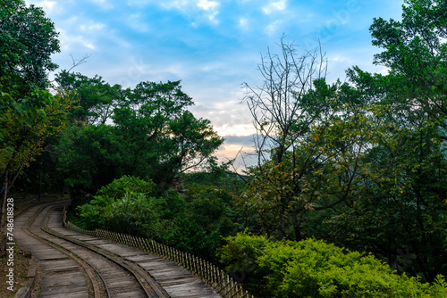 Abandoned train way in the mountain with green plants surrounded, in Jinguashi, New Taipei City, Taiwan.