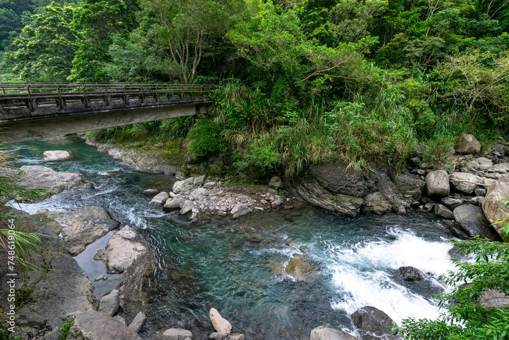 Beautiful green water go through the valley and a stone bridge across the river, in sanxia, New Taipei City, Taiwan.