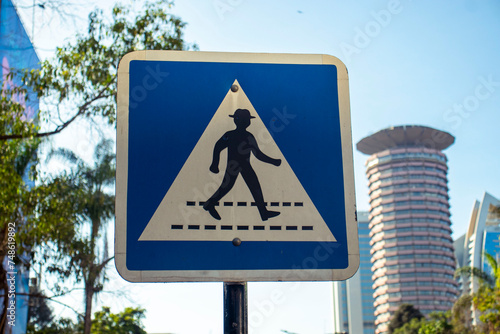 pedestrian crossing sign on blue sky