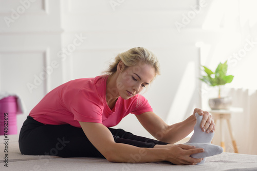 Portrait of active and flexible young woman practicing yoga alone