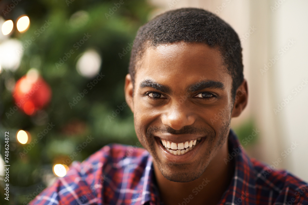 Man, portrait and smile in home on christmas for celebration, holiday and festive spirit in living room. African person, face and happy on xmas with relax, confidence and vacation in lounge of house Man, portrait and smile in home on christmas for celebration, holiday and festive spirit in living room. African person, face and happy on xmas with relax, confidence and vacation in lounge of house