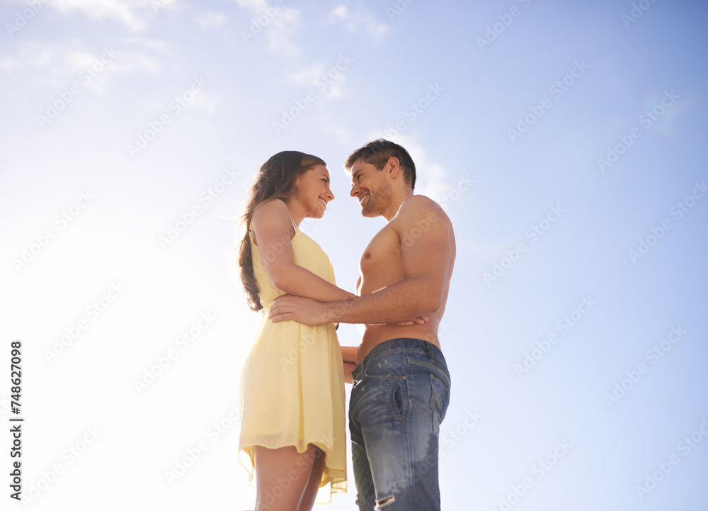 Summer, sky and low angle of couple with love in embrace with care, support or happiness in background. Holiday, travel or man with woman on vacation, adventure in Florida and smile with partner Summer, sky and low angle of couple with love in embrace with care, support or happiness in background. Holiday, travel or man with woman on vacation, adventure in Florida and smile with partner
