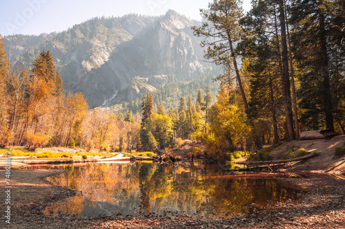 Serene lake surrounded by a colorful autumn mountain landscape