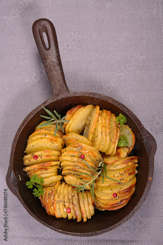 baked sliced potatoes and herbs