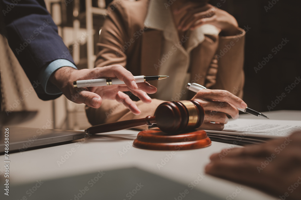 A group of lawyers is discussing contract documents that must be presented to a client, Lawyers brainstorm to revise important documents that must be submitted to the Supreme Court.