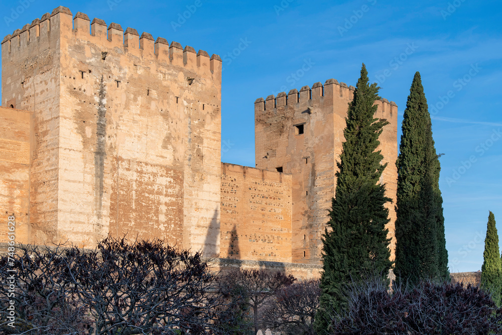 Morning sunrise on building and surrounding fortified wall and canon in front of The Alhambra palace, Granada, Spain, with Islamic and Spanish architecture