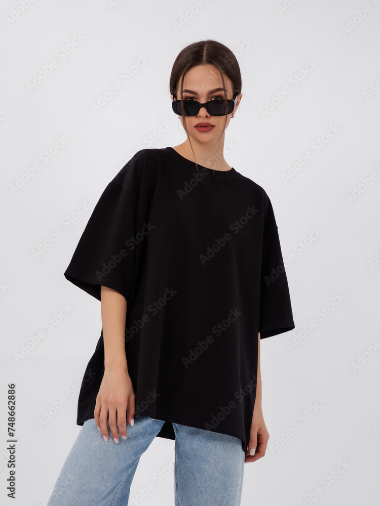 mockup of a black loose-fitting t-shirt on a young beautiful girl mockup of a black loose-fitting t-shirt on a young beautiful girl