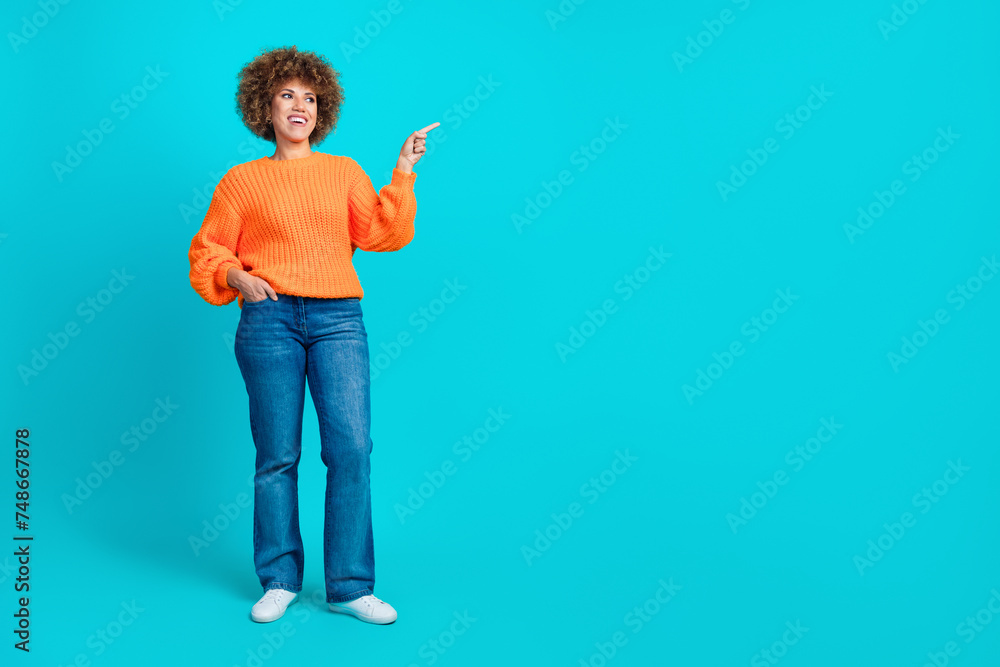 Full length photo of lovely cheerful lady wear stylish clothes demonstrate special offer empty space isolated on blue color background