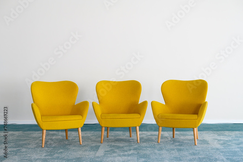 Elegant modern yellow armchairs in room