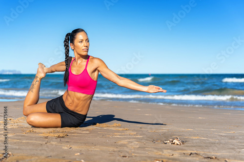 Middle aged woman exercising on the beach this summer