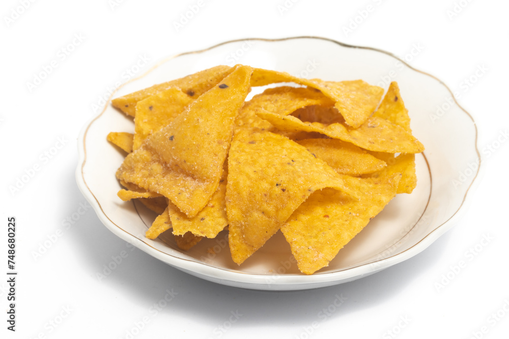 Crispy corn tortilla nachos chips in a small white plate isolated on white background clipping path Crispy corn tortilla nachos chips in a small white plate isolated on white background clipping path