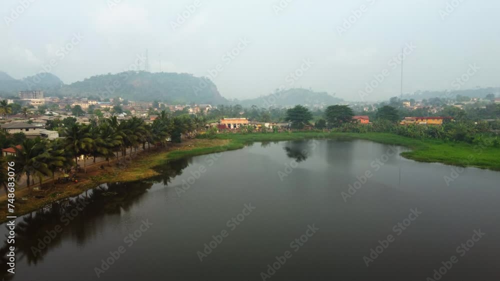 Aerial view over the Lac Muncipal lake, hazy day in Ebolowa city, Cameroon Aerial view over the Lac Muncipal lake, hazy day in Ebolowa city, Cameroon