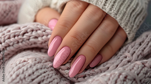 a woman's hand with a pink manicure on her nails