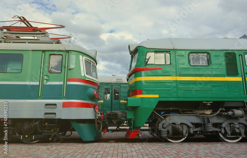 Cabs of modern Russian electric trains. Side view of the heads of railway trains with a lot of wheels and windows in the form of portholes.