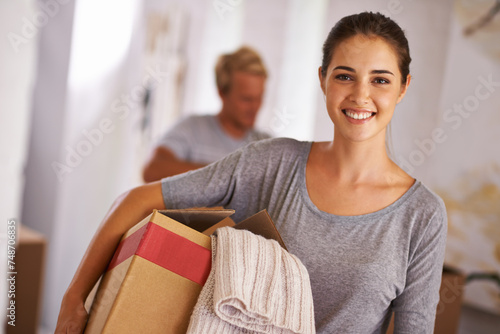 Home, woman and happy with box for moving in with clothes, satisfied and property ownership. Portrait, people and packing furniture in new house with investment, real estate for growth and future. photo