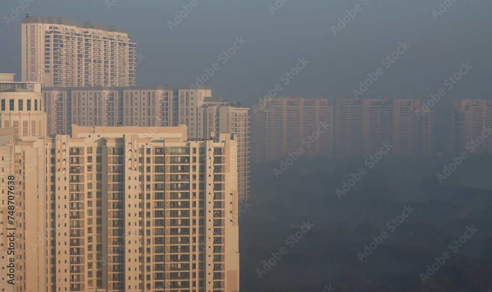 Gurgaon,Haryana,India skyline on a foggy winter morning.Aerial view of Gurugram urban cityscape with modern architecture,commercial ,luxury residential apartment buildings.Delhi NCR.