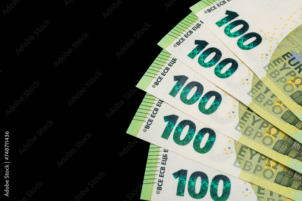 100 euro bills euro banknotes money on dark background. European Union Currency 100 euro bills euro banknotes money on dark background. European Union Currency