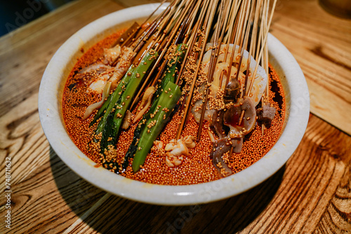 Obraz na płótnie Leshan pot chicken has been a traditional Sichuan snack for 100 years, which refers to cold slices of chicken, served with chili sauce containing many spices in a pottery pot (Bobo). w salonie