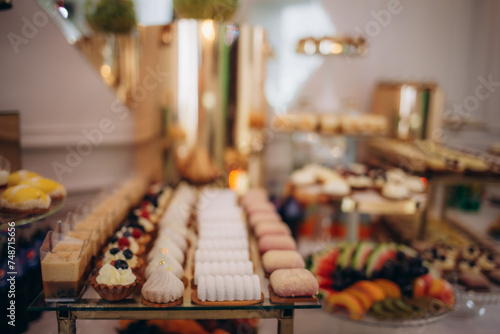 A delicious wedding. Candy bar for a banquet. Celebration concept. Fashionable desserts. Table with sweets, candies. Fruits