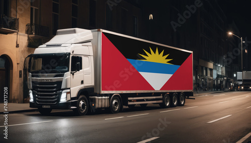 A truck with the national flag of Antigua and Barbuda depicted carries goods to another country along the highway. Concept of export-import,transportation, national delivery of goods.