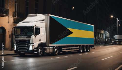 A truck with the national flag of Bahamas depicted carries goods to another country along the highway. Concept of export-import,transportation, national delivery of goods.