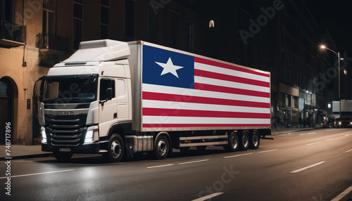 A truck with the national flag of Liberia depicted carries goods to another country along the highway. Concept of export-import,transportation, national delivery of goods.