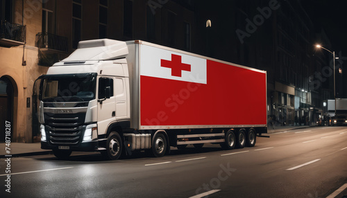 A truck with the national flag of Tonga depicted carries goods to another country along the highway. Concept of export-import,transportation, national delivery of goods.