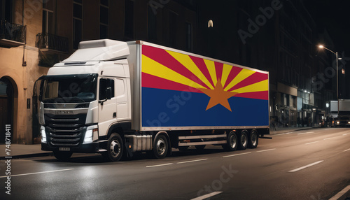 A truck with the national flag of Arizona depicted carries goods to another country along the highway. Concept of export-import,transportation, national delivery of goods.