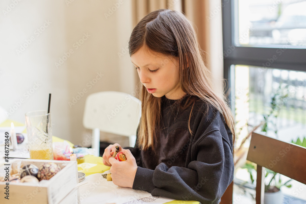 Child Girl Focused on Easter Egg Decorating