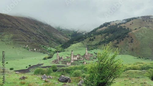 Wallpaper Mural View of the medieval Targim tower complex in the Caucasus mountains surrounded by greenery. The Caucasus Mountains on a cloudy day in Ingushetia. Russia, 4K. Torontodigital.ca